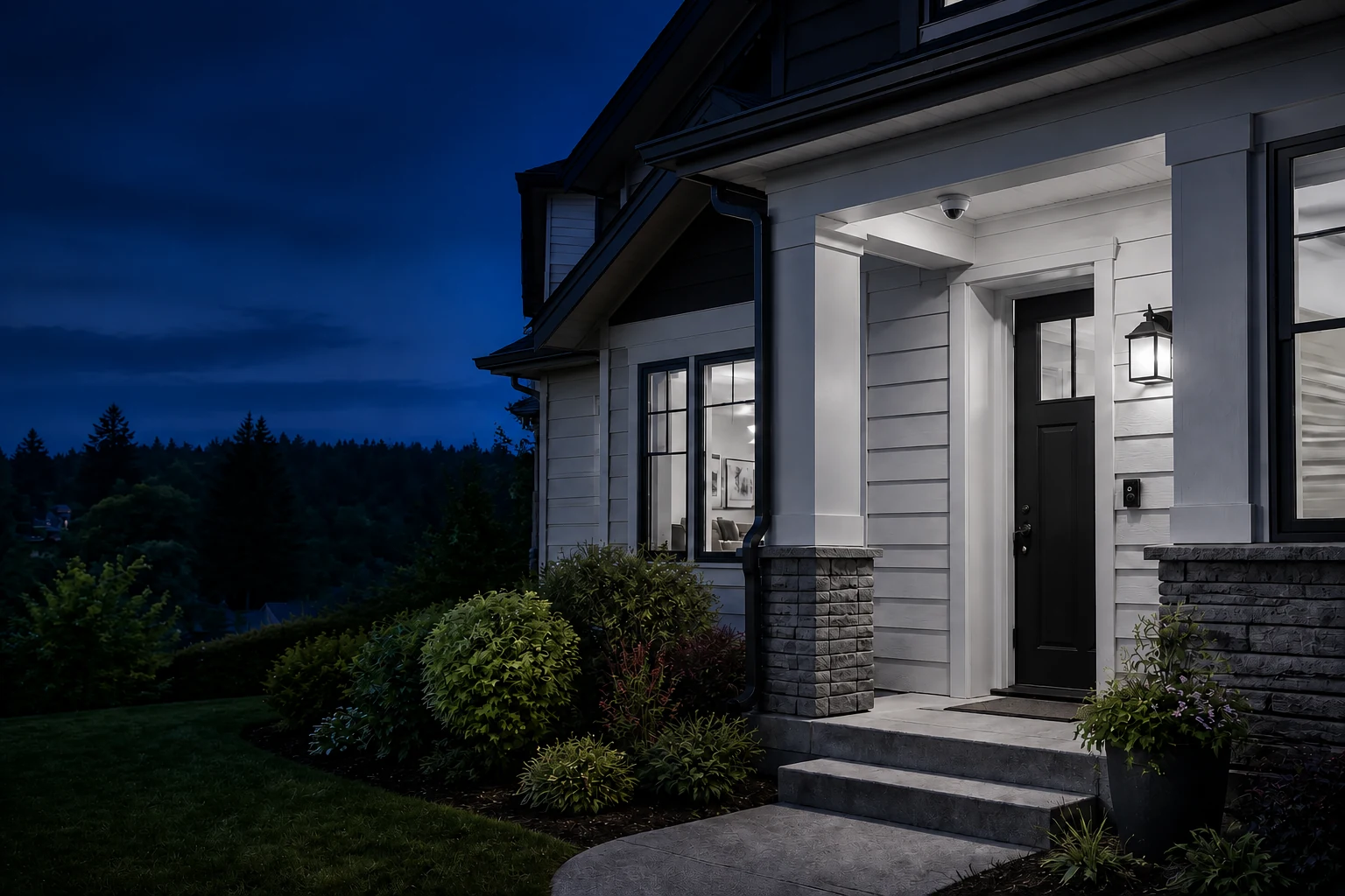 A home with neutral-white entry lighting at blue hour